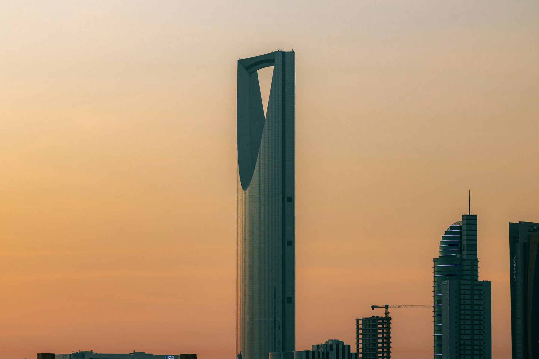 Kingdom Centre rising above Riyadh against a warm evening sky
